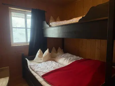 a bedroom with a bunk bed with white pillows at Beitotind 1504 in Beitostøl