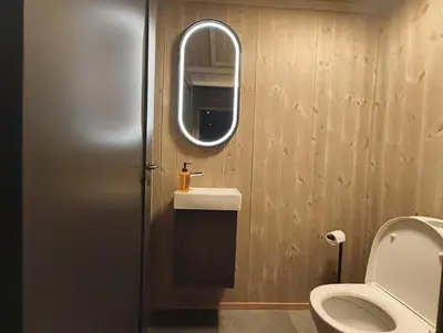 a bathroom with a toilet and a sink and a mirror at Hytte-13 Cozy cabin close to Kvitfjell in Fåvang