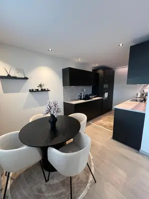a kitchen and dining room with a table and chairs at Leilighet i trondheim in Trondheim