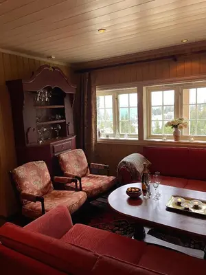 a living room with a couch and chairs and a table at Cozy cabin apartment, ski-in ski-out at Kvitfjell in Kvitfjell