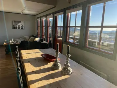 a dining room table with two candles on top of it at Cozy Top-Floor Apartment With Fireplace And Sauna in Beitostøl