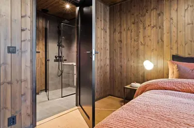 a bedroom with a glass shower and a bed at Ski in-out - 3BR, 2 Bath Chalet apartment - Favn Hafjell in Hafjell