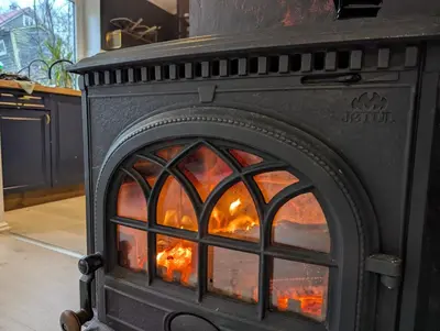 a stove with a fire inside of it at Fjord View Cabin Near Bergen & Nature in Grottveit