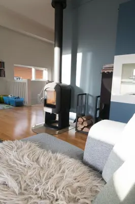 a living room with a fireplace and a couch at Spacious house, close to Granåsen Ski Arena! 4 beds, 2 bathrooms, free parking in Trondheim