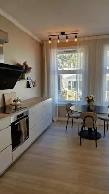 a kitchen with a table and a dining room at Jugend City Retreat - Ålesund Apartment in Ålesund