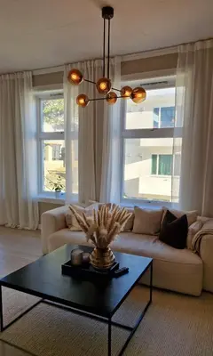 a living room with a couch and a table at Jugend City Retreat - Ålesund Apartment in Ålesund