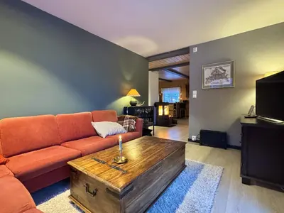 a living room with a couch and a wooden coffee table at Charming Cabin Near Hallingskarvet Ski Center, Cozy and Inviting! in Skoro