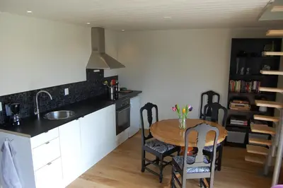 a kitchen with a table and chairs in a room at Apartment on Golsfjellet! in Gol