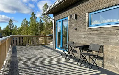 a wooden deck with a table and chairs on it at 3 Bedroom Cozy Home In Rendalen in Rendalen