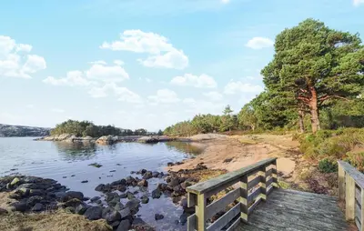 a wooden bridge over a body of water at Gorgeous Home In Eivindvik With Wifi in Eivindvik