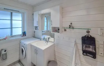 a bathroom with a sink and a washing machine at Gorgeous Home In Eivindvik With Wifi in Eivindvik