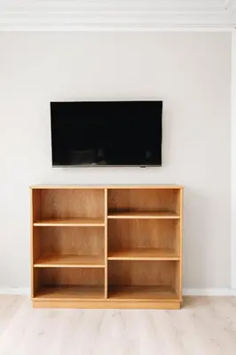 a entertainment center with shelves and a television on a wall at Dinbnb Home - History meets Modern I 3-Story Bergen House in Bergen