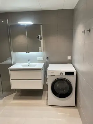 a bathroom with a washing machine and a sink at New Powerhouse apartment in Lade in Trondheim in Trondheim