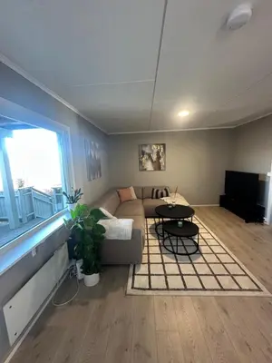 a living room with a couch and a table at Cozy Apartment in Lillehammer in Lillehammer