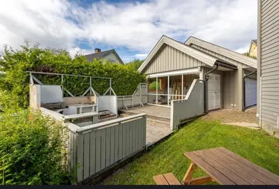 a backyard of a house with a fence at Cozy Apartment in Lillehammer in Lillehammer