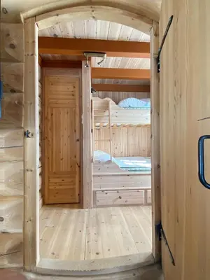 a door in a room with two bunk beds at Kvenahytta in Markegardlian