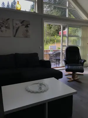 a living room with a couch and a table and a chair at Amazing home in the heart of Nordfjordeid in Nordfjordeid