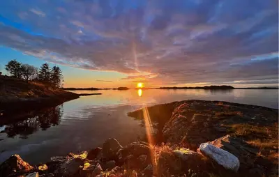 a sunset over a body of water with the sun setting at 4 Bedroom Gorgeous Home In Atløy in Herland
