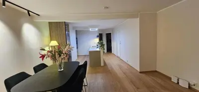 a living room with a table and chairs and a hallway at Best view in town in Bergen