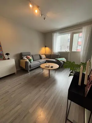 a living room with a couch and a table at 1-bedroom apartment in Trondheim