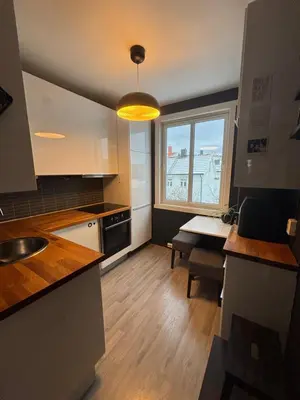 a small kitchen with a table and a window at 1-bedroom apartment in Trondheim