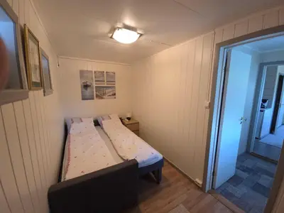 a small bedroom with a bed in a room at Hardangerfjord panorama 2 in Kvam