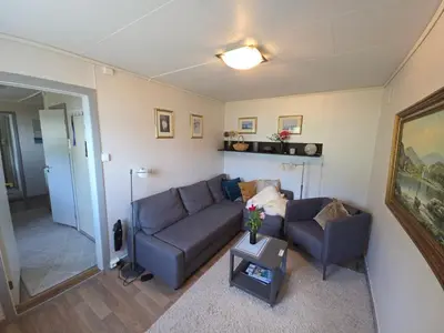 a living room with a couch and a table at Hardangerfjord panorama 2 in Kvam