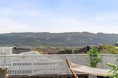 a hammock on a balcony with a white fence at World Cup Trondheim 2025 in Trondheim