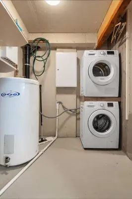 a laundry room with a washing machine and a washer at Guesthouse-Ølen, 2 bedroom in Dørheim