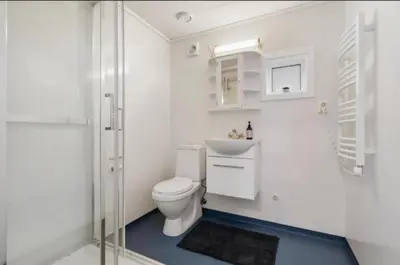 a bathroom with a toilet and a sink and a shower at Guesthouse-Ølen, 2 bedroom in Dørheim