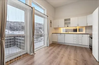 a large kitchen with white cabinets and large windows at Guesthouse-Ølen, 2 bedroom in Dørheim