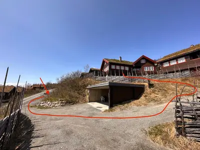 a house with a hose on the side of a road at Skiidyll Med Utsikt Og Peis in Beitostøl