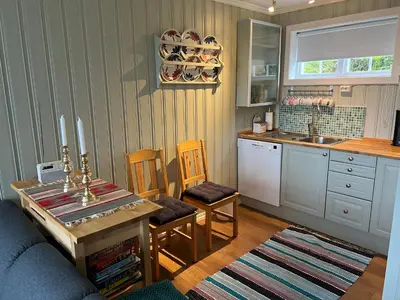a kitchen with a table and a kitchen with a sink at Skiidyll Med Utsikt Og Peis in Beitostøl