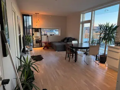 a living room with a table and a couch at Near Granåsen in Trondheim