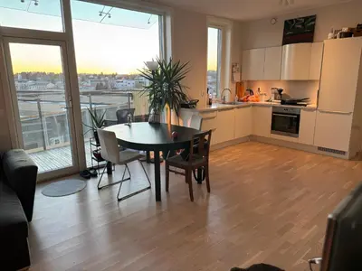 a kitchen and dining room with a table and a view at Near Granåsen in Trondheim