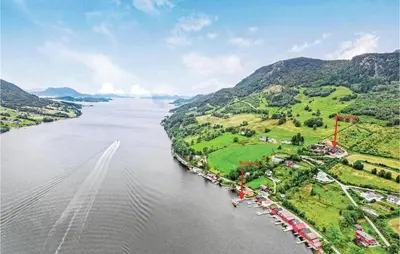 an aerial view of a river with a boat at 10 Bedroom Amazing Home In Ølen in Ølen