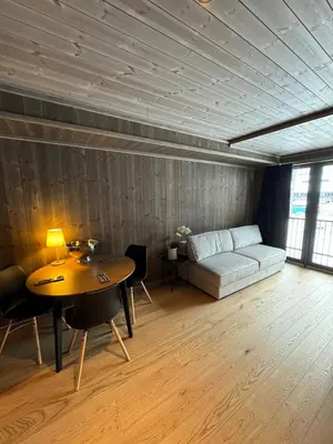 a living room with a table and a couch at New! Apartment Fjellandsbyen Hemsedal Ski&bike in Kyrkjebøen