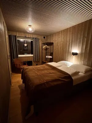 a bedroom with a large bed and a desk at Ustedalen Lodge in Geilo