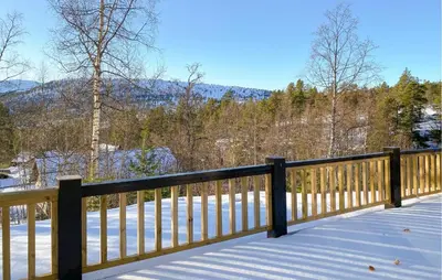 a wooden fence with snow on the ground at Cozy Home In Stryn With Sauna in Stryn