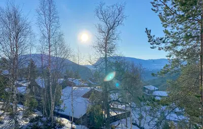 a view of a snowy mountain with the sun in the sky at Cozy Home In Stryn With Sauna in Stryn