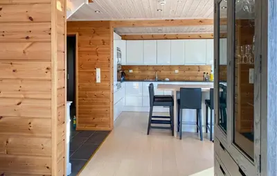 a kitchen with wooden walls and a table and chairs at Cozy Home In Stryn With Sauna in Stryn