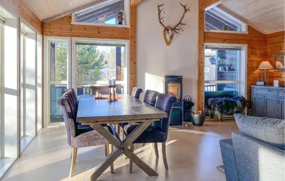 a dining room with a wooden table and chairs at Cozy Home In Stryn With Sauna in Stryn