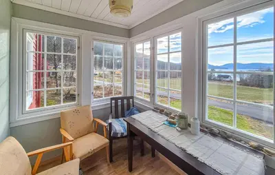 a dining room with windows and a table and chairs at Amazing Home In Kysnesstrand With Wifi in Oppheim