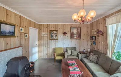 a living room with a couch and a table at Amazing Home In Kysnesstrand With Wifi in Oppheim