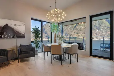 a dining room with a table and chairs at Penthouse with fjord view and parking in Sogndal