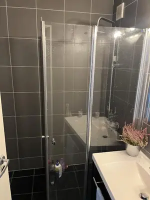 a shower with a glass door in a bathroom at Trondheim in Trondheim