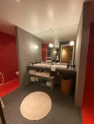a bathroom with a sink and a large mirror at Luxury private house with Amazing view! in Trondheim