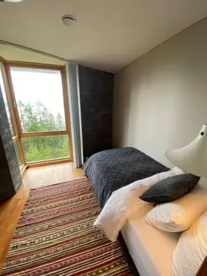 a bedroom with a bed and a large window at Luxury private house with Amazing view! in Trondheim