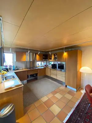 a large kitchen with a counter top at Luxury private house with Amazing view! in Trondheim