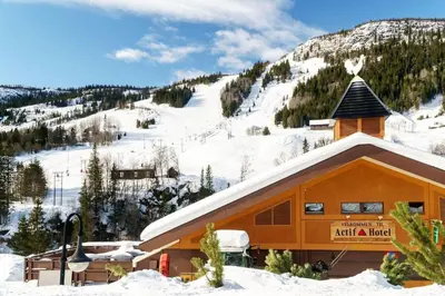a ski lodge with a snow covered mountain in the background at Actif 318 apartment - close to ski slopes in Ål in Ål